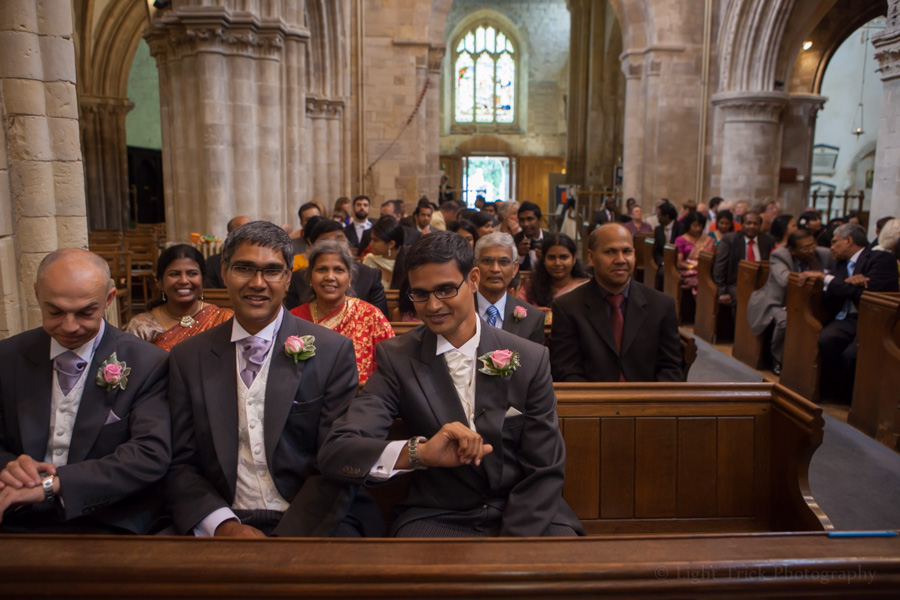 groom looking at his watch in a church